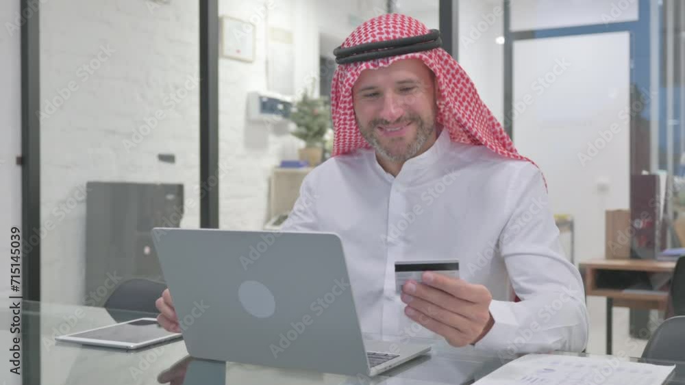 Excited Middle Aged Muslim Man Enjoying Online Shopping Excited Middle Aged Muslim Man Enjoying Online Shopping
