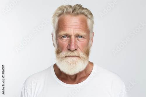 Portrait of senior man with white beard and mustache. Studio shot.