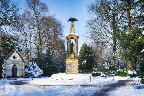 the central square with the eagle column of cologne's melaten cemetery covered in snow