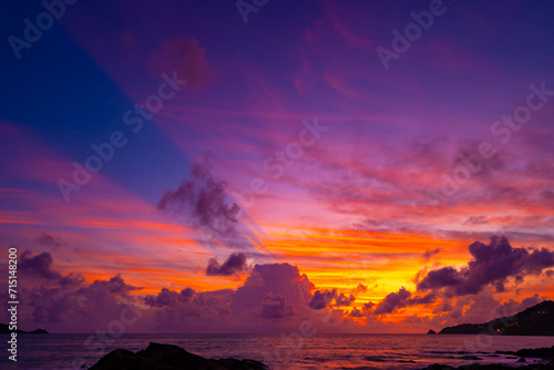 Beautiful colorful sunset or sunrise sky over sea with dramatic clouds nature environment background