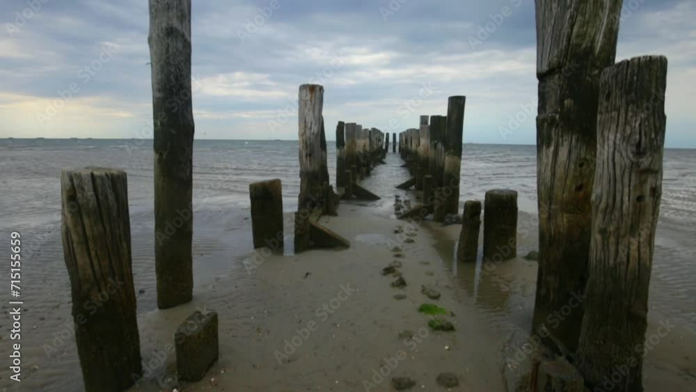 destroyed wooden pillars in the sea on a cloudy day. sea pier.4k footage destroyed wooden pillars in the sea on a cloudy day. sea pier.4k footage
