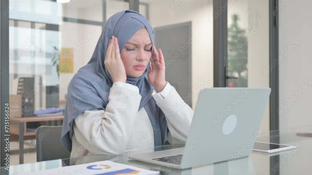 Woman in Hijab having Headache while Working on Laptop Woman in Hijab having Headache while Working on Laptop