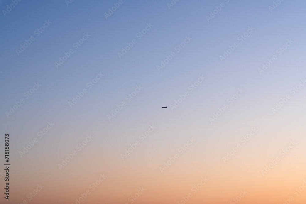 airplane in the air during sunset
