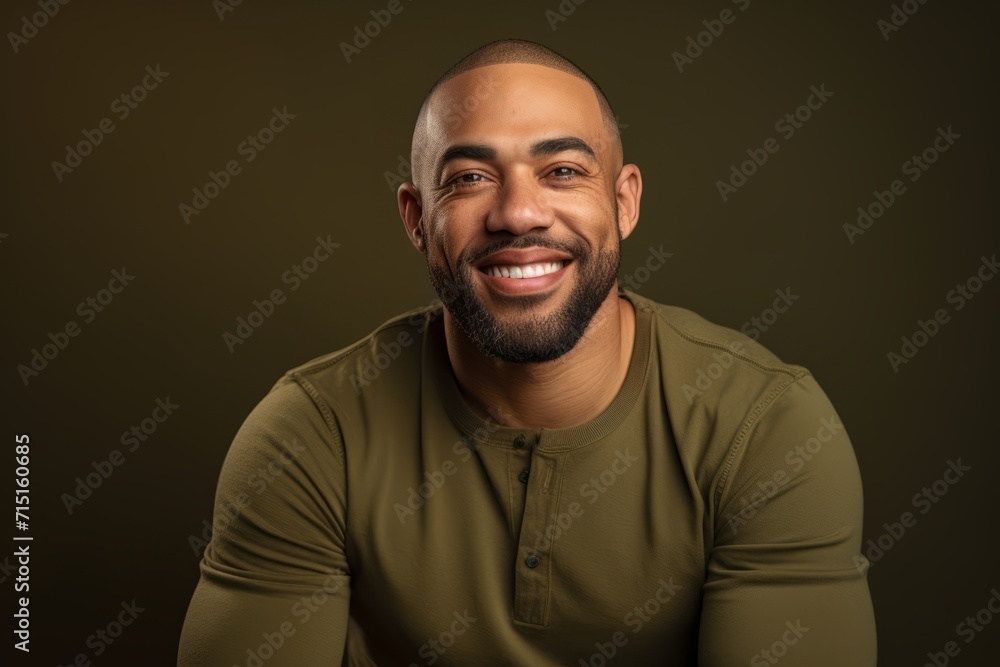Handsome african american man smiling at camera on dark background Handsome african american man smiling at camera on dark background
