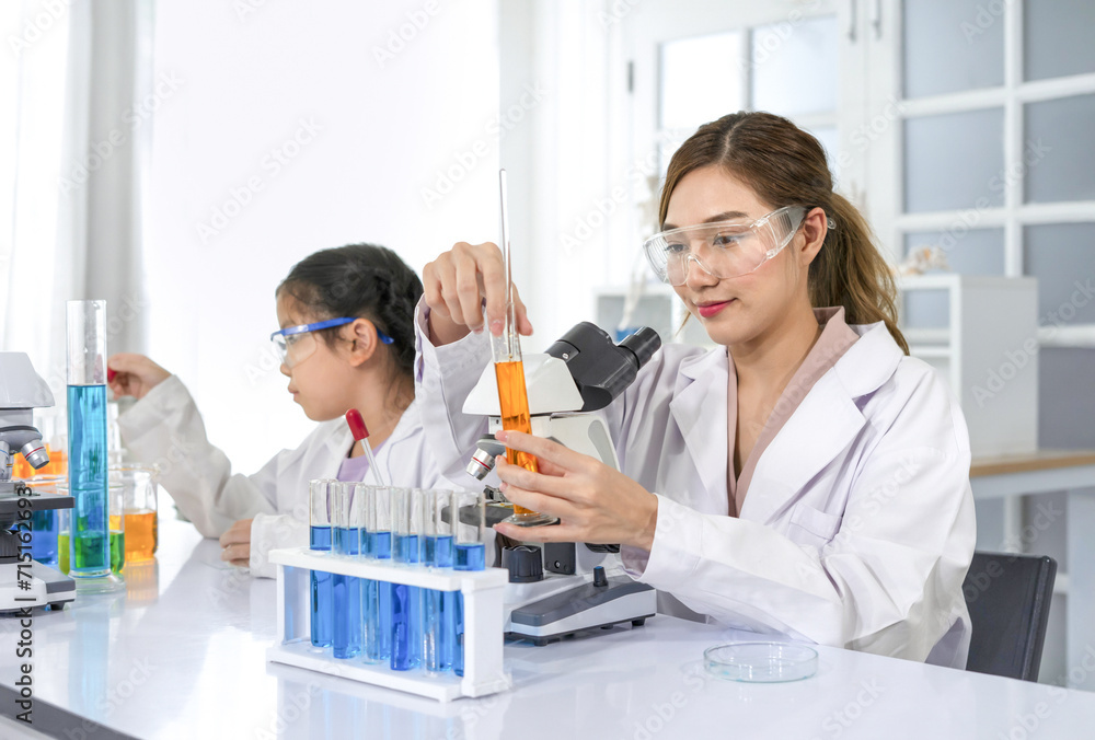portrait young asian woman as a mentor teaching student in chemical laboratory,scientist in uniform working in workplace room portrait young asian woman as a mentor teaching student in chemical laboratory,scientist in uniform working in workplace room