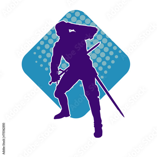 Silhouette of a male warrior wearing war armor suit in action pose using a sword weapon.