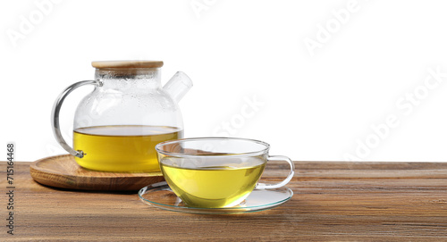 Refreshing green tea in cup and teapot on wooden table against white background