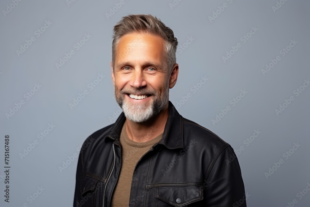 Portrait of a happy mature man in leather jacket over grey background Portrait of a happy mature man in leather jacket over grey background
