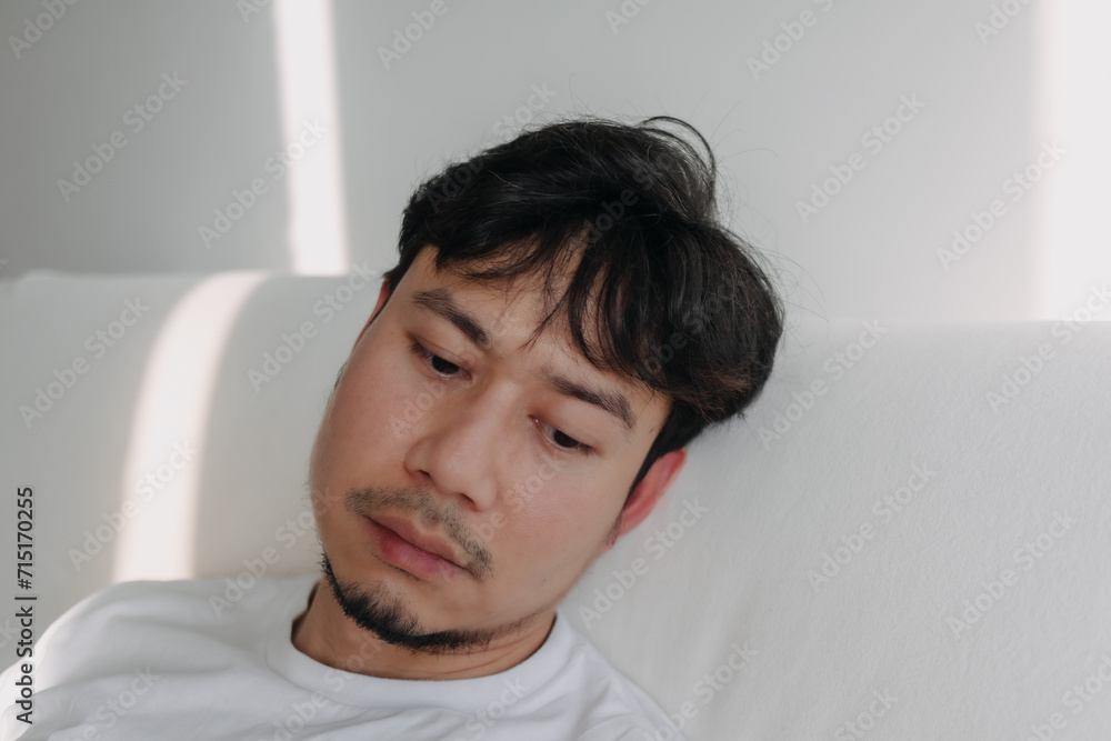 Close up face of lonely Asian man feeling depressed and bored in low light room. Close up face of lonely Asian man feeling depressed and bored in low light room.