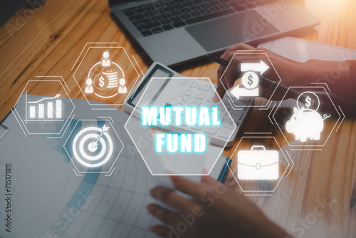 Mutual fund concept, Business woman using calculator on desk with mutual fund icon on virtual screen. Securities, Cash Flow, Money, Investment, Stock Exchange, Trade. photo