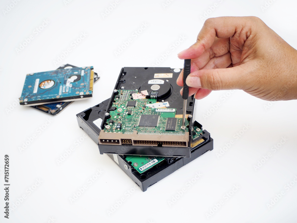 hand holding a screwdriver to repairing hard drive hand holding a screwdriver to repairing hard drive