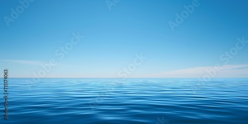 serene water surface reflecting the serene beauty of a clear blue sky © BackgroundWorld