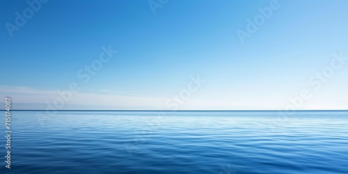 serene water surface reflecting the serene beauty of a clear blue sky