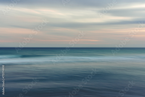 Ocean and cloudy sky  abstract seascape background  motion blur.