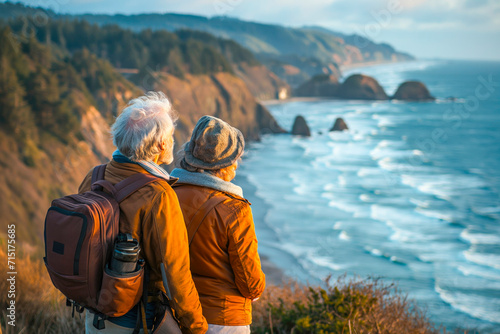 Senior couple admiring the scenic Pacific coast while hiking, filled with wonder at the beauty of nature during their active retirement. Concept of well being and leisure © MVProductions