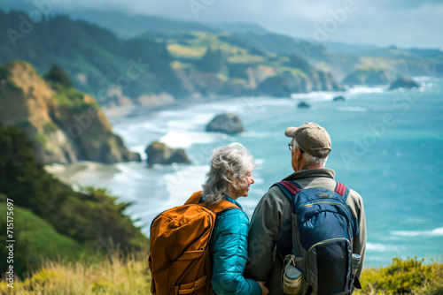 Senior couple admiring the scenic Pacific coast while hiking, filled with wonder at the beauty of nature during their active retirement. Concept of well being and leisure