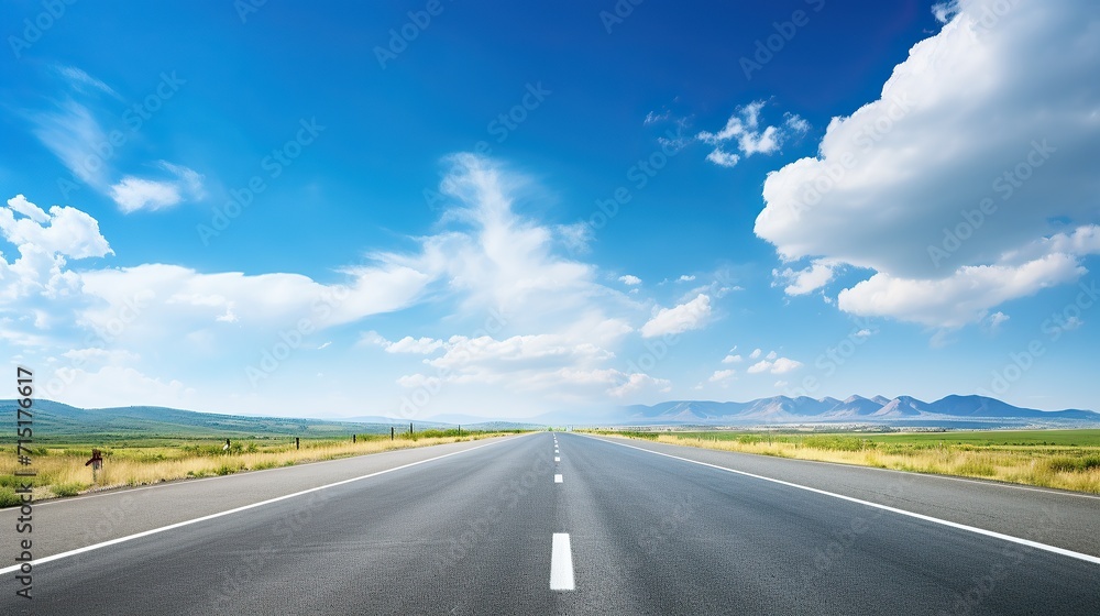 asphalt road with white lines, sunny view, blue sky with clouds above,
