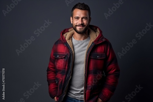 Portrait of a handsome man in a red jacket on a dark background