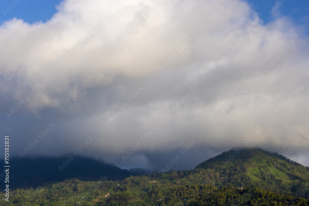 Heavy clouds over a dense forest, mountains of Bali near Munduk, Indonesia