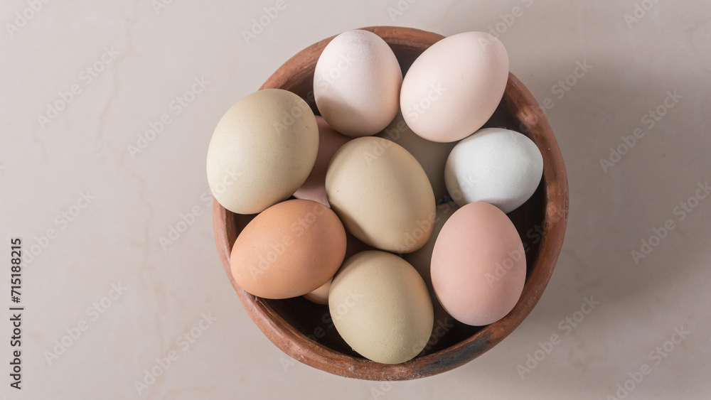 Basket of chicken eggs on the table, colorful big eggs, organic food, natural protein Basket of chicken eggs on the table, colorful big eggs, organic food, natural protein