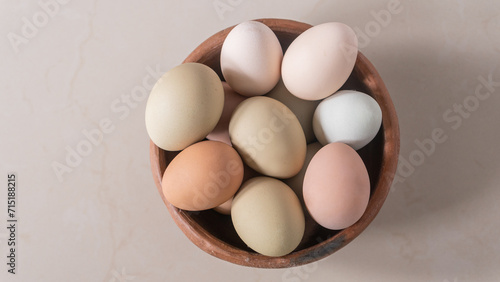 Basket of chicken eggs on the table, colorful big eggs, organic food, natural protein