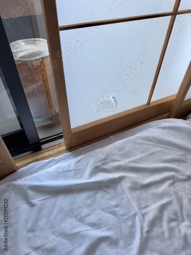 A guest staying in a traditional Japanese onsen ryokan hotel accidentally broken the paper shoji window screen