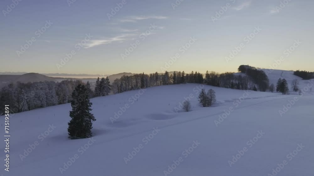 Low sun over the Jura mountains in winter with snow, depressions in the snow as geological formations, called sinkholes, Brunnersberg, second Jura mountain range, drone image, Matzendorf, Solothurn Low sun over the Jura mountains in winter with snow, depressions in the snow as geological formations, called sinkholes, Brunnersberg, second Jura mountain range, drone image, Matzendorf, Solothurn