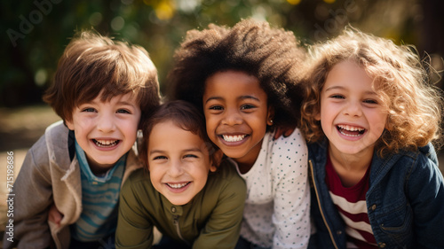 Group of diverse cheerful fun happy multiethnic children outdoors in the sunshine