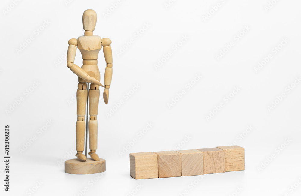 Wooden doll with wooden toy block isolated on white background. business or creative concept Wooden doll with wooden toy block isolated on white background. business or creative concept