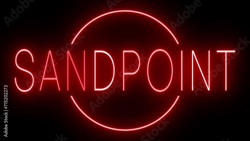 Flickering red retro style neon sign glowing against a black background for SANDPOINT photo
