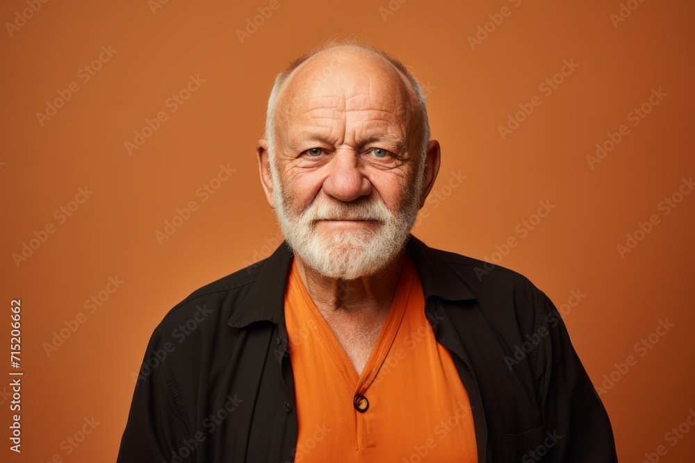 Portrait of a senior man with grey beard and mustache. Isolated on orange background. Portrait of a senior man with grey beard and mustache. Isolated on orange background.