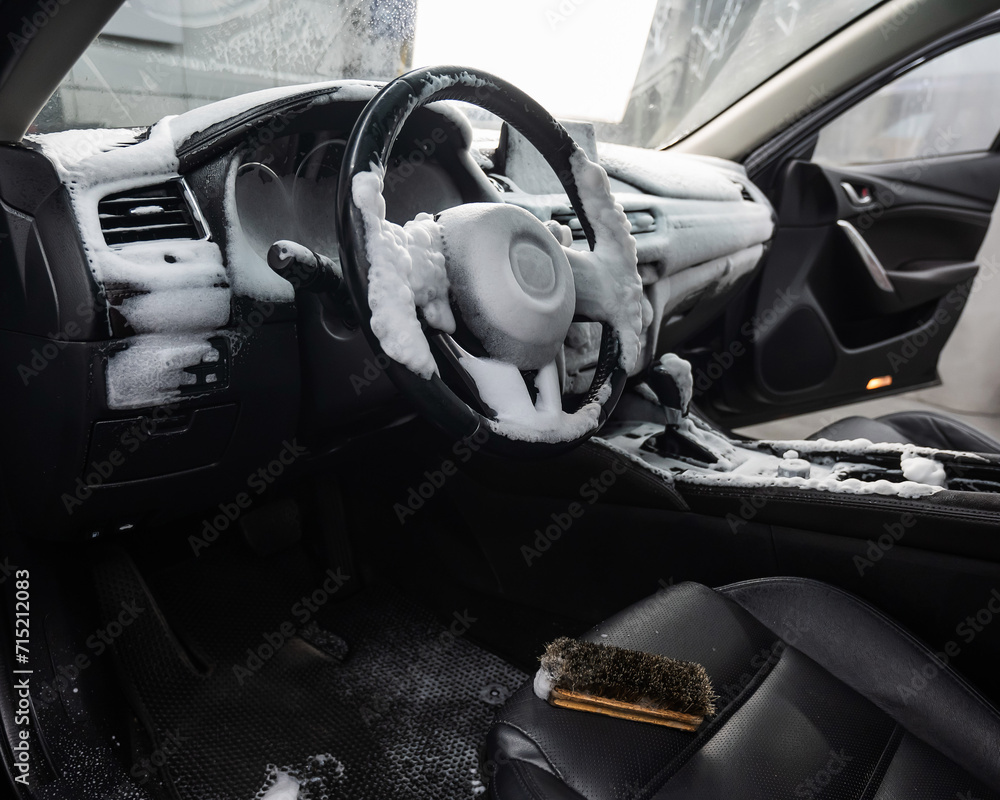 Car interior in a layer of cleaning foam. 
