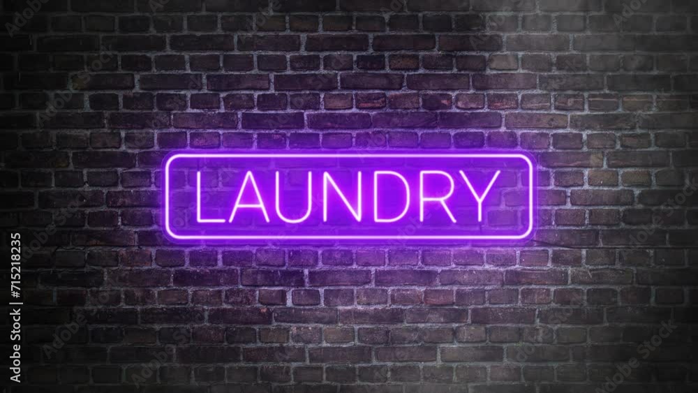 Laundry neon signboard on bricks wall background. Concept of laundry store front. Illuminated laundry sign with rounded rectangle frame in purple neon. Laundry neon signboard on bricks wall background. Concept of laundry store front. Illuminated laundry sign with rounded rectangle frame in purple neon.