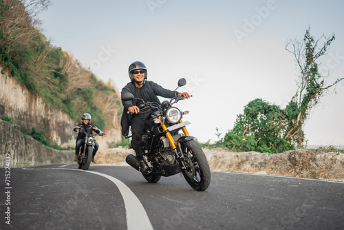 indonesian riders on the road riding motorcycle traveling together © Odua Images