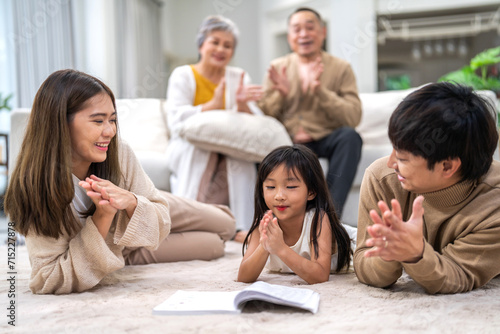 Portrait happy love asian family father and mother teach little daughter asian girl learn and study.Mom and asian young girl reading book making lessons in homeschool at home.Education © Art_Photo