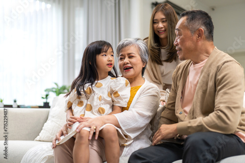 Portrait of happy love family asian father and mother playing with adorable asian kid girl.daughter  care  insurance.Happy family moments good time love with grandparents.Love of big family.