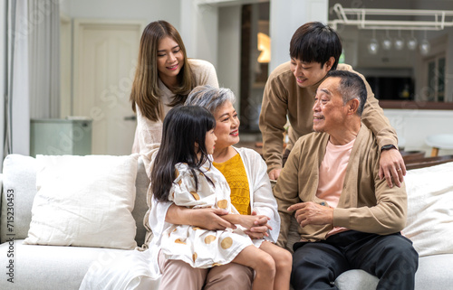 Portrait of happy love family asian father and mother playing with adorable asian kid girl.daughter, care, insurance.Happy family moments good time love with grandparents.Love of big family.