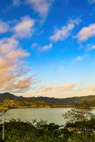 Panoramic portrait of a natural view of a lake surrounded by mountains in Indonesia on a sunny morning
