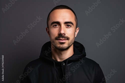 Portrait of a handsome young man in a black sweatshirt. © Inigo