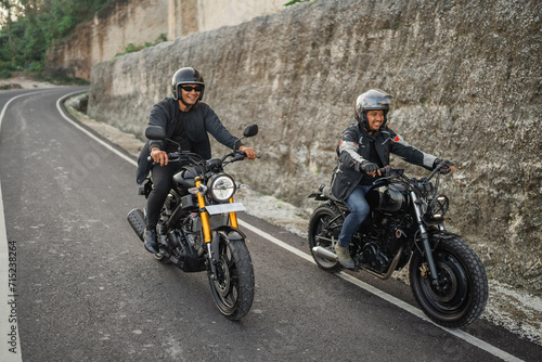 Fototapeta Naklejka Na Ścianę i Meble -  indonesian riders on jacket and helmet traveling on the street by motorbike