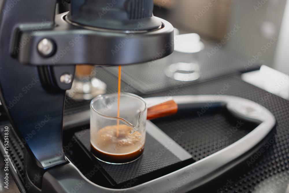 Hot espresso is poured from the coffee machine. Professional coffee brewing Hot espresso is poured from the coffee machine. Professional coffee brewing