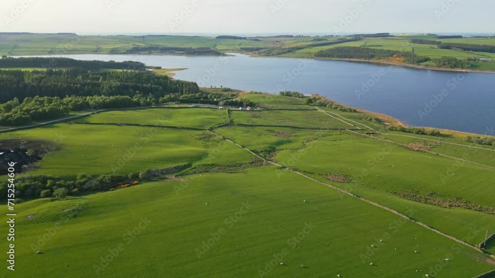 A drone shot of the english countryside with a lake. A drone shot of the english countryside with a lake.