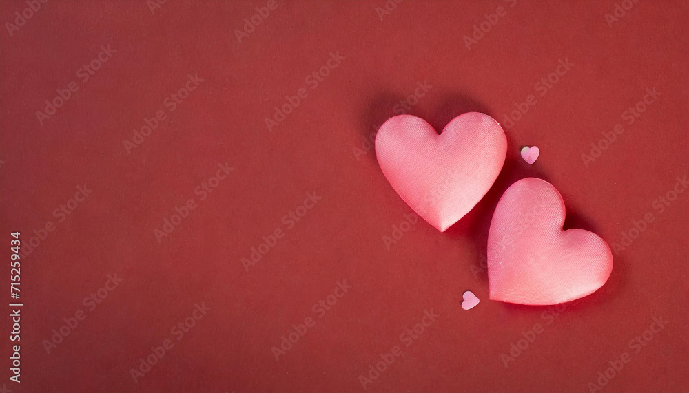 Two pink hearts on red background, place for writing