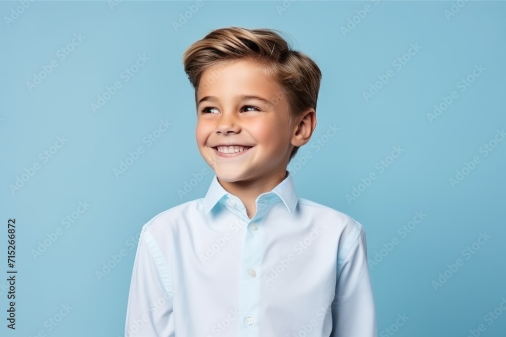 Portrait of a smiling little boy in a blue shirt on a blue background Portrait of a smiling little boy in a blue shirt on a blue background