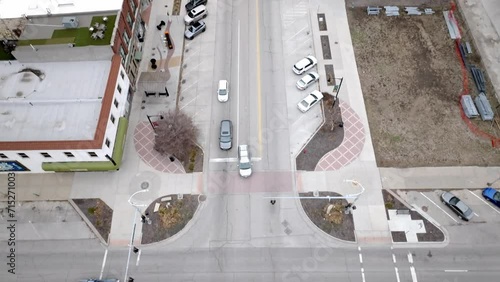 Intersection with cars moving in downtown Topeka, Kansas with overhead drone video tilting up. photo