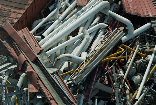 Canvas Print Old building pipes and tubes ready for recycling after dismantling from architec
