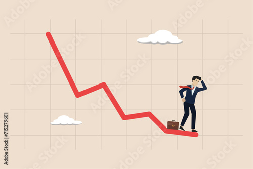 Economic recession, financial crisis from inflation concept, stock market decline, businessman investor standing on falling down red graph look for bottom.