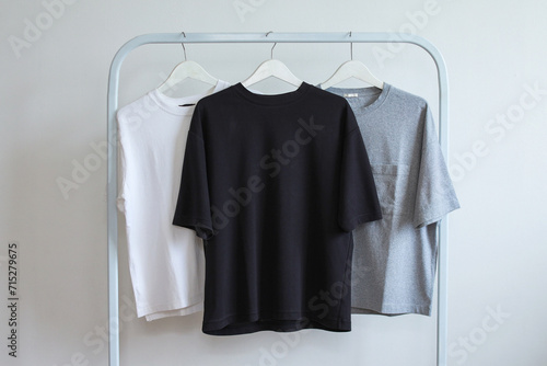Collection t-shirts of monochrome variant displayed on a white clothes hanger