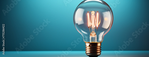 Glowing light bulb on blue background