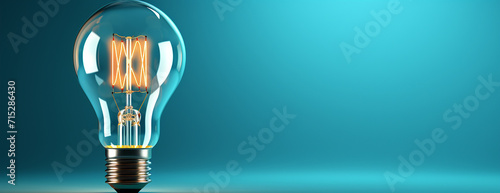 Glowing light bulb on blue background